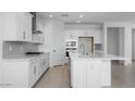 Bright kitchen featuring white cabinets, stainless steel appliances, and a large island at 9054 S 169Th Dr, Goodyear, AZ 85338