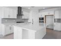 Bright kitchen featuring white cabinets, stainless steel appliances, and a large island at 9054 S 169Th Dr, Goodyear, AZ 85338