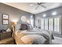 Spacious bedroom with a ceiling fan and plush bedding at 9100 E Raintree Dr # 232, Scottsdale, AZ 85260