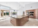 Gourmet kitchen featuring granite island and stainless steel appliances at 10410 N 74Th Pl, Scottsdale, AZ 85258