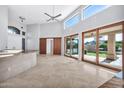 Open living room showcasing tile floors and sliding glass doors at 10410 N 74Th Pl, Scottsdale, AZ 85258