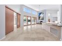 Spacious living room with high ceilings, fireplace, and large windows at 10410 N 74Th Pl, Scottsdale, AZ 85258