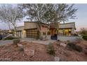 Striking exterior elevation featuring a modern design, three-car garage, and desert landscaping at 15949 E Ridgestone Dr, Fountain Hills, AZ 85268