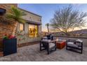 Relaxing outdoor living space with a fire pit, comfortable chairs, and picturesque mountain views at 15949 E Ridgestone Dr, Fountain Hills, AZ 85268