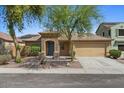 Inviting home with a well-manicured front yard and a two-car garage providing comfort and curb appeal at 17750 W Watson Ln, Surprise, AZ 85388