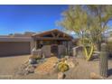 Front entry of Spanish-style home with wooden gate and walkway at 1854 Century Way, Carefree, AZ 85377