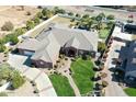 Aerial view of a red brick home with a lush lawn, mature landscaping, driveway and beautiful community at 2222 N Val Vista Dr # 2, Mesa, AZ 85213