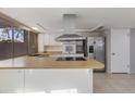 Modern kitchen featuring stainless steel appliances and wood countertops at 225 N Standage St # 78, Mesa, AZ 85201