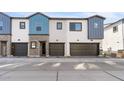 Front view of three-unit townhome building with attached garages at 2821 W White Feather Ln, Phoenix, AZ 85085
