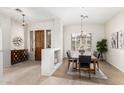 Charming dining area features a wooden table with seating for six and a decorative chandelier at 42017 N Crooked Stick Rd, Anthem, AZ 85086