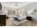 Spacious main bedroom features a plush bed, soft rug, and shuttered windows for natural light at 42017 N Crooked Stick Rd, Anthem, AZ 85086