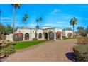 Elegant single-story residence featuring a grand columned entrance, beautiful desert flora, and a paver driveway at 4340 E Turquoise Ave, Phoenix, AZ 85028