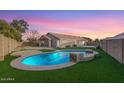 Inviting backyard oasis with a sparkling pool and grassy area at 4446 W Townley Ave, Glendale, AZ 85302