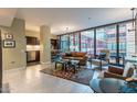 Open living area with leather sofa, large windows, and city views at 4808 N 24Th St # 305, Phoenix, AZ 85016