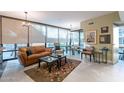Open living area with leather sofa, large windows, and city views at 4808 N 24Th St # 305, Phoenix, AZ 85016