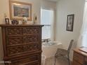 Cozy bedroom featuring a dresser, window seat, and chair at 5518 E Lindstrom Ln # 2004, Mesa, AZ 85215