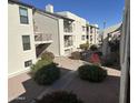 Building exterior showcasing a well-maintained courtyard with landscaping and walkways at 5518 E Lindstrom Ln # 2004, Mesa, AZ 85215