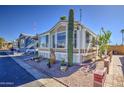 This home features an eye-catching cactus and easy desert landscaping at 7750 E Broadway Rd # 906, Mesa, AZ 85208