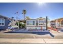 Cozy manufactured home with desert landscaping, covered parking, and easy access to community amenities at 7750 E Broadway Rd # 906, Mesa, AZ 85208