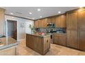 Well-equipped kitchen offering granite countertops, a center island, and stainless steel appliances at 7844 E Coolidge St, Scottsdale, AZ 85251