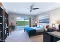Bright main bedroom with ceiling fan and sliding door access to the pool at 7844 E Coolidge St, Scottsdale, AZ 85251