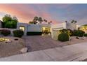 Stunning home exterior with desert landscaping, palm trees, and a brick driveway at 8708 E San Lucas Dr, Scottsdale, AZ 85258