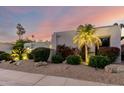 Expansive yard featuring desert landscaping, boulders and an illuminated palm tree at 8708 E San Lucas Dr, Scottsdale, AZ 85258
