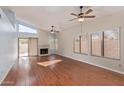 Spacious living room with hardwood floors, fireplace, and sliding door to patio at 9429 E Camino Del Santo --, Scottsdale, AZ 85260