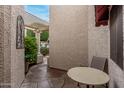 Private patio area with stone flooring, perfect for outdoor seating and enjoying the serene surroundings at 9478 N 105Th St, Scottsdale, AZ 85258