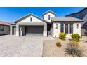 Modern two-story home with a brick facade and a two-car garage at 11682 W Parkway Ln, Avondale, AZ 85323