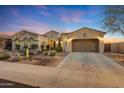 Beautiful single-story home with desert landscaping and a three-car garage at 18125 W Acacia Dr, Goodyear, AZ 85338