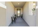 Inviting entrance featuring a cozy seating area and a decorative glass front door at 27395 W Wahalla Ln, Buckeye, AZ 85396