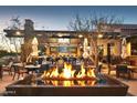 Inviting outdoor fire pit and bar setting, perfect for entertaining guests and relaxing under the stars at 27395 W Wahalla Ln, Buckeye, AZ 85396