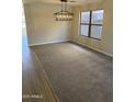 Bright dining room with chandelier, hardwood floors, and large windows at 28756 N Desert Hills Dr, San Tan Valley, AZ 85143