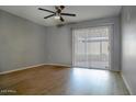 Spacious bedroom with wood-look flooring and sliding glass doors to patio at 3331 W Del Monico Ln, Phoenix, AZ 85051