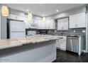 Modern kitchen featuring white cabinets, granite countertops, and stainless steel appliances at 3331 W Del Monico Ln, Phoenix, AZ 85051