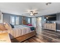 Spacious main bedroom with a barn door, large TV, and plenty of natural light at 38100 W Santa Clara Ave, Maricopa, AZ 85138