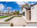 Elegant home featuring a well-kept white brick exterior, black window trim, and an extended front patio at 412 W Vermont W Ave, Phoenix, AZ 85013