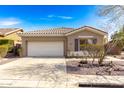 Charming single-story home featuring a two-car garage, desert landscaping, and a neutral color scheme at 41216 N Shadow Creek Ct, Anthem, AZ 85086