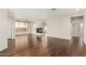 Hardwood floor living room with fireplace and lots of open area at 41216 N Shadow Creek Ct, Anthem, AZ 85086