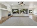 Spacious living room with large windows and neutral color palette at 42950 W Misty Morning Ln, Maricopa, AZ 85138