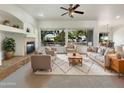 Bright living room featuring a fireplace and ample natural light at 42950 W Misty Morning Ln, Maricopa, AZ 85138