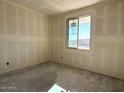 Spacious room featuring an unfinished wall and a large window offering ample natural light at 4509 S 95Th Dr, Tolleson, AZ 85353