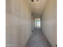 Hallway boasts drywall walls and a clear view of the backyard through large glass windows at 4517 S 95Th Dr, Tolleson, AZ 85353