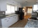White kitchen cabinets, granite countertops, and stainless steel appliances at 7419 E Abilene Ave, Mesa, AZ 85208