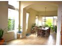 Bright dining room with large windows, modern lighting, and tile floors at 7712 S 25Th Ave, Phoenix, AZ 85041