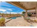Inviting backyard patio featuring pool, outdoor seating, and desert views at 9523 E Sandy Vista Dr, Scottsdale, AZ 85262