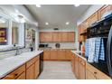 Well-lit kitchen features bright countertops, stylish cabinets, and modern appliances at 10256 N 105Th Dr, Sun City, AZ 85351