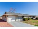 House exterior with a single car garage and neat landscaping at 10450 W Campana Dr, Sun City, AZ 85351