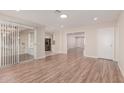 Bright living room with hardwood floors and view into kitchen at 10450 W Campana Dr, Sun City, AZ 85351